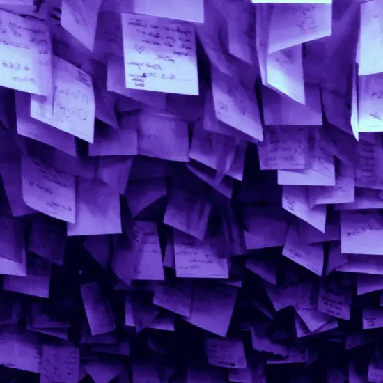A wall of handwritten notes in violet